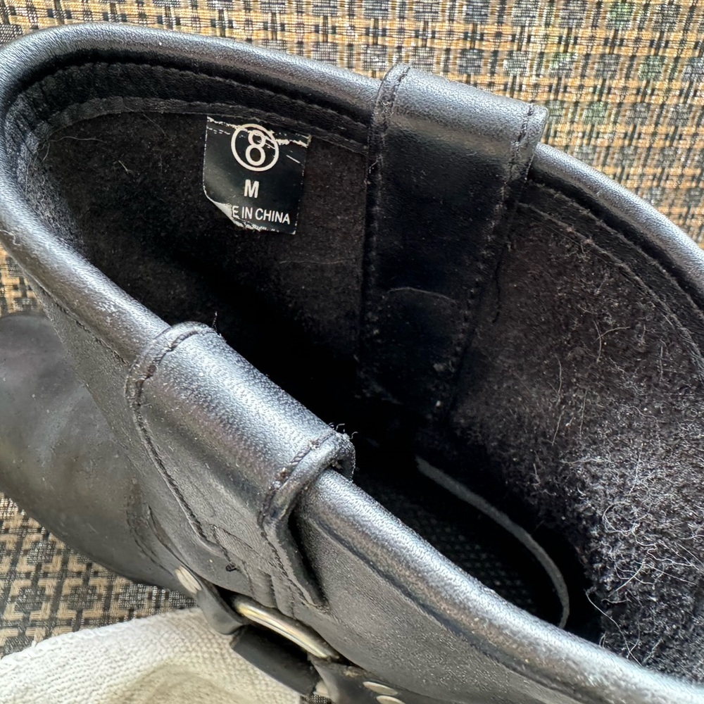Black leather riding boots.
